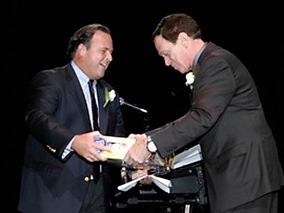 Peter Cancro (l., getdate(), getdate() ), Founder and CEO, Jersey Mike's Subs, presents Comic Joe Piscopo (r.) with authentic Jersey Mike's Subs direct from Point Pleasant.